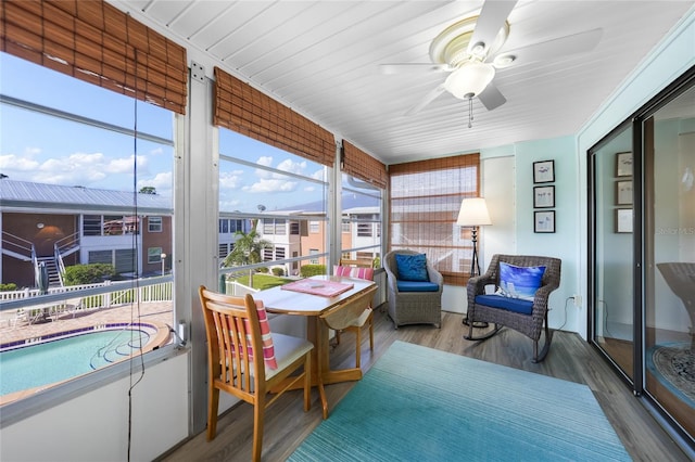 sunroom featuring ceiling fan