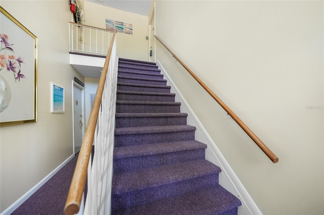 stairs featuring carpet flooring