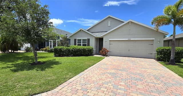 view of front of house with a front yard and a garage