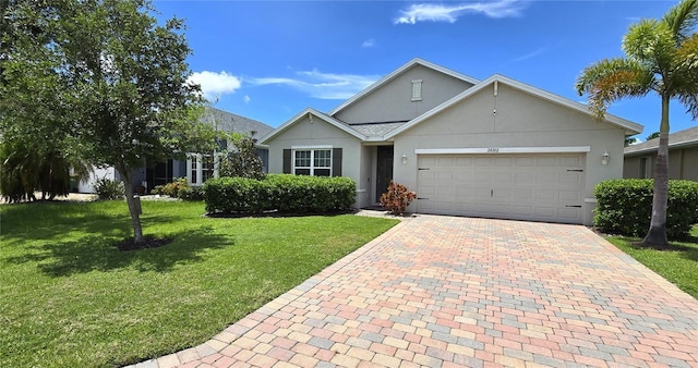 view of front of property featuring a garage and a front yard