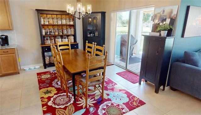 dining area featuring an inviting chandelier and light tile patterned flooring