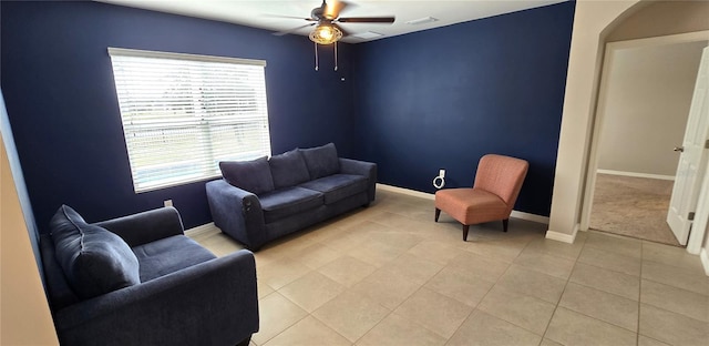 tiled living room with ceiling fan