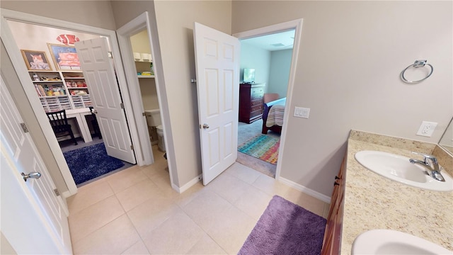 bathroom featuring tile patterned floors, vanity, and toilet