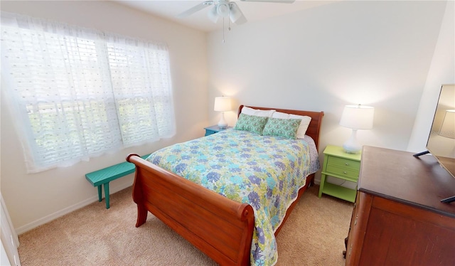 bedroom featuring light carpet and ceiling fan