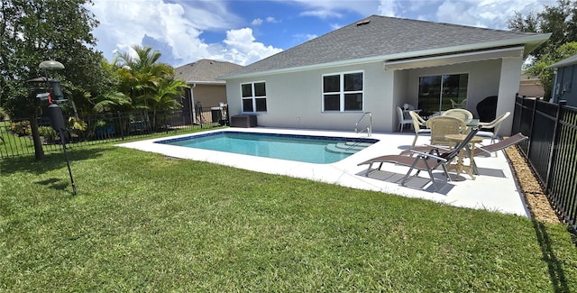 view of pool featuring a lawn and a patio area