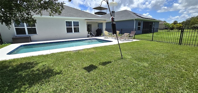 view of pool with a patio area and a lawn