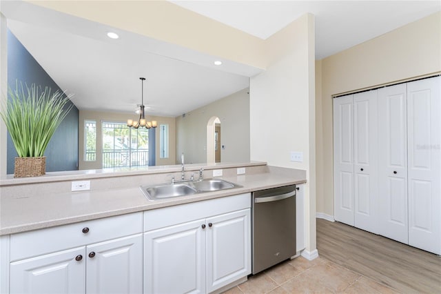 kitchen with dishwasher, light hardwood / wood-style flooring, sink, white cabinets, and a notable chandelier