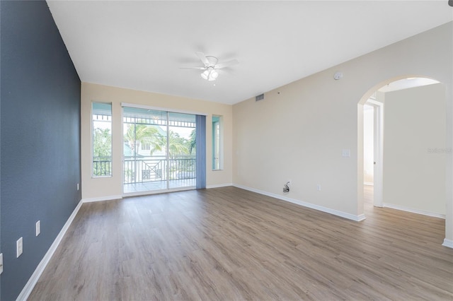 empty room with ceiling fan and wood-type flooring