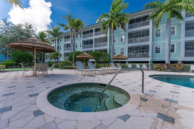 view of pool with a patio area and a community hot tub