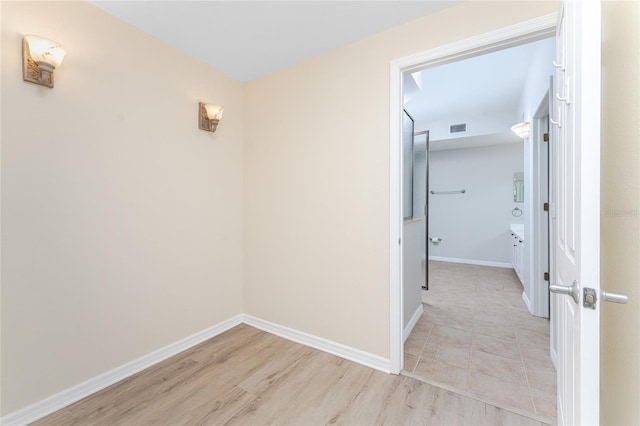 corridor with light tile patterned floors