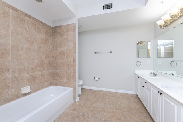 bathroom with toilet, vanity, and tile patterned floors