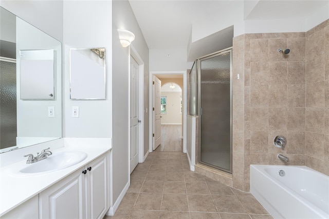 bathroom featuring tile patterned floors, independent shower and bath, and vanity