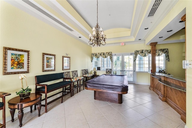 recreation room with billiards, a notable chandelier, a raised ceiling, and light tile patterned floors