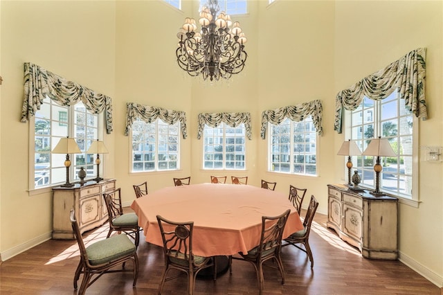 dining room with a wealth of natural light, an inviting chandelier, and hardwood / wood-style flooring