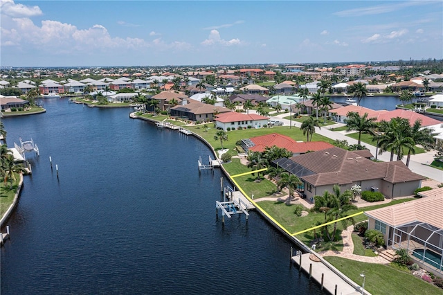 drone / aerial view with a water view and a residential view