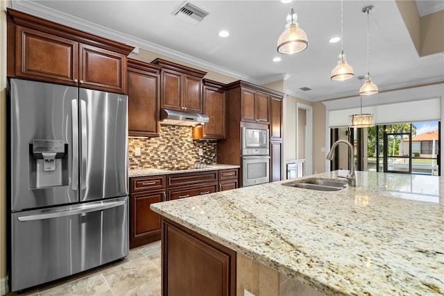 kitchen with appliances with stainless steel finishes, light tile patterned flooring, decorative light fixtures, backsplash, and sink