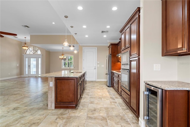 kitchen featuring appliances with stainless steel finishes, beverage cooler, light tile patterned floors, and a center island with sink