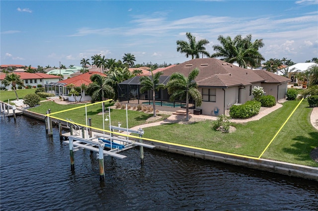 view of dock featuring a lawn, glass enclosure, and a water view