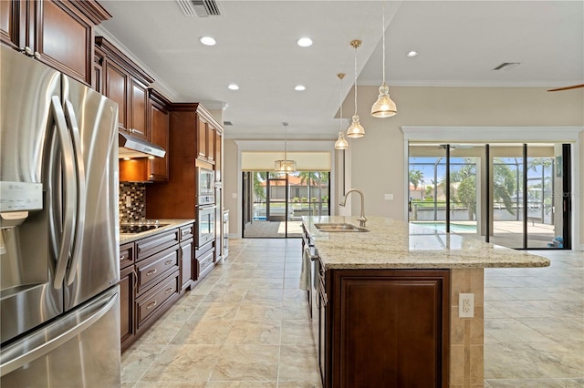 kitchen with appliances with stainless steel finishes, sink, a healthy amount of sunlight, and light tile patterned floors