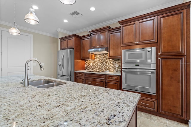 kitchen featuring pendant lighting, light tile patterned floors, appliances with stainless steel finishes, sink, and tasteful backsplash