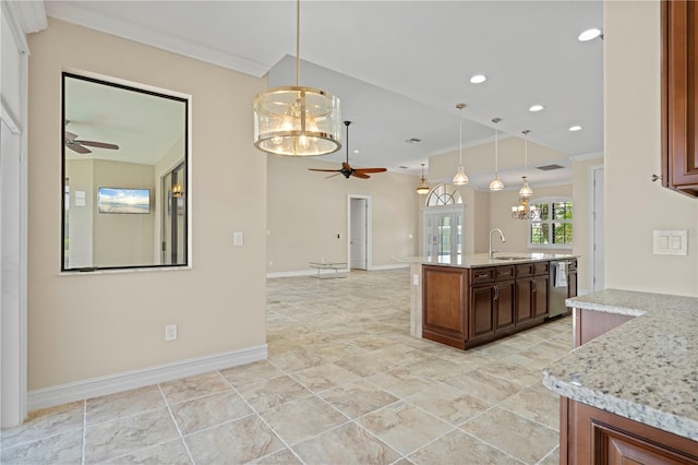 kitchen with ceiling fan with notable chandelier, hanging light fixtures, and light stone countertops