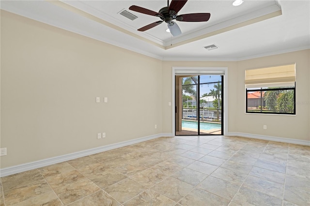 unfurnished room featuring ceiling fan, light tile patterned flooring, a tray ceiling, and crown molding