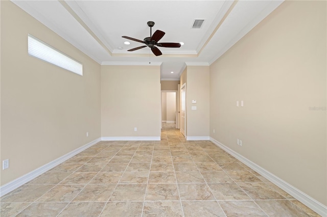 tiled spare room featuring ceiling fan, crown molding, and a tray ceiling