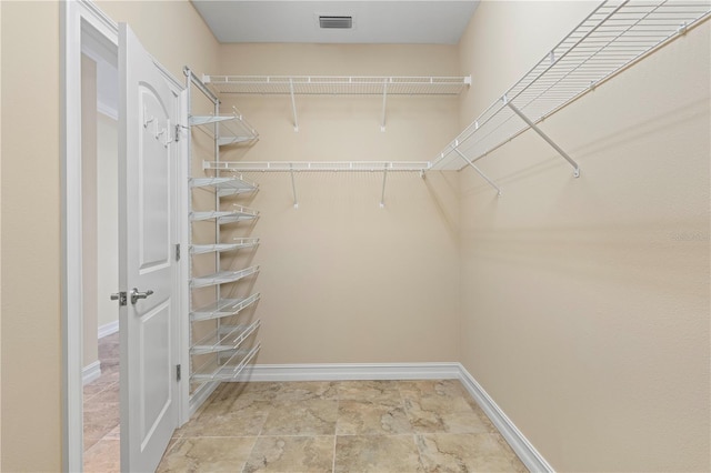 spacious closet featuring light tile patterned flooring