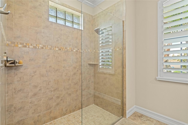 bathroom with tile patterned floors, plenty of natural light, and tiled shower