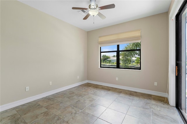 unfurnished room with visible vents, ceiling fan, and baseboards