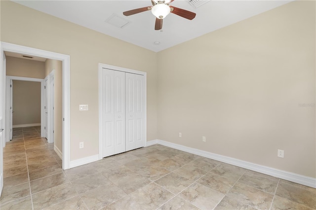 unfurnished bedroom featuring ceiling fan, light tile patterned flooring, and a closet