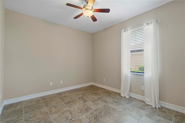 unfurnished room with ceiling fan, baseboards, and a wealth of natural light