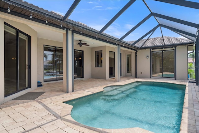 pool featuring ceiling fan, a patio, and glass enclosure