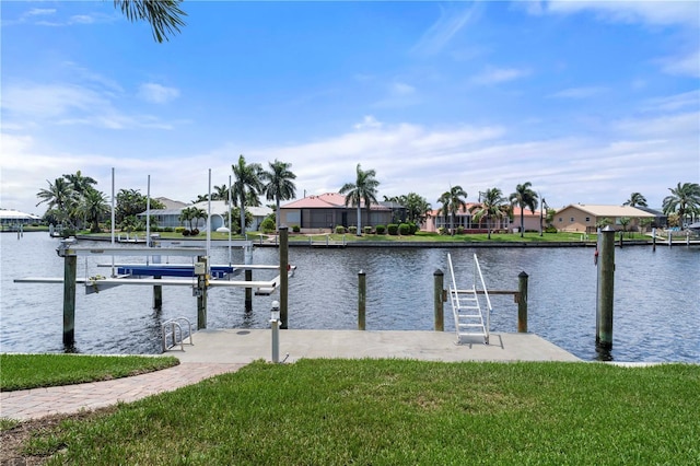 dock area with a yard, a water view, boat lift, and a residential view