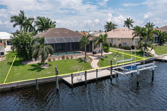 rear view of property featuring glass enclosure, a water view, and a yard