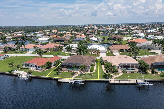 birds eye view of property featuring a water view and a residential view