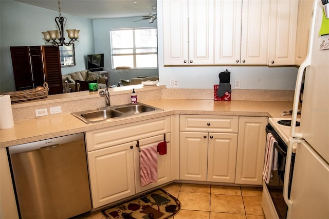 kitchen featuring white appliances, ceiling fan with notable chandelier, light tile patterned flooring, white cabinetry, and sink