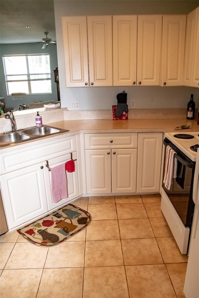 kitchen with white range with electric cooktop, light tile patterned floors, sink, and ceiling fan