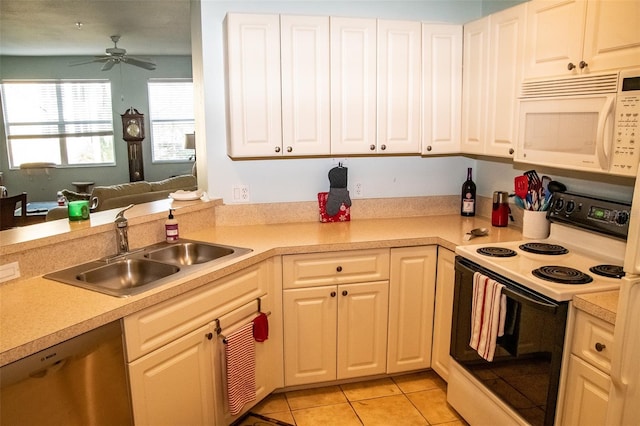 kitchen with white appliances, ceiling fan, sink, light tile patterned flooring, and white cabinetry