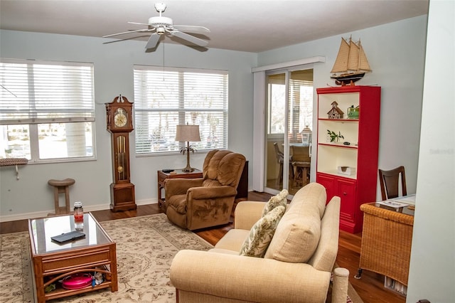 living area with ceiling fan and wood-type flooring