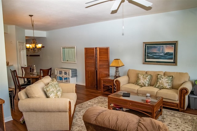 living room featuring ceiling fan with notable chandelier and wood-type flooring