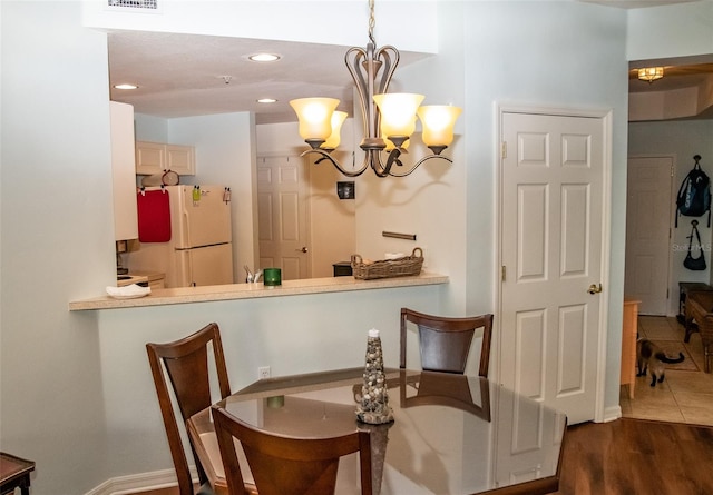 dining space featuring a notable chandelier and hardwood / wood-style floors