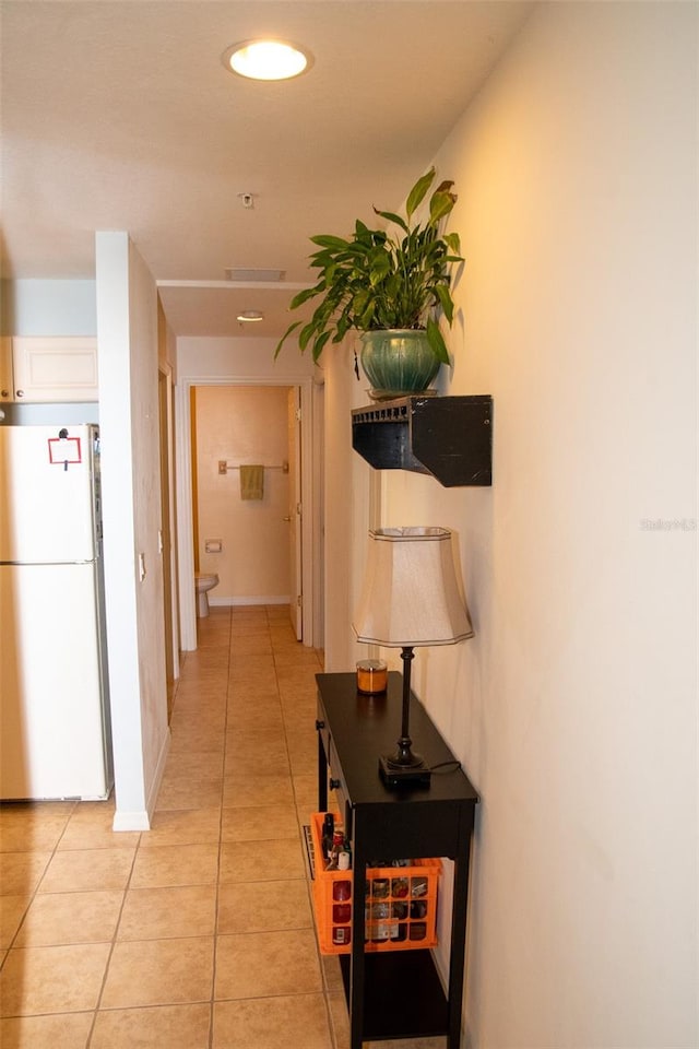 hall with light tile patterned floors