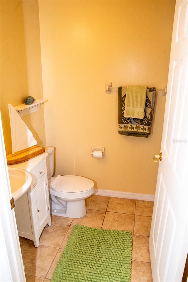 bathroom featuring vanity, toilet, and tile patterned flooring