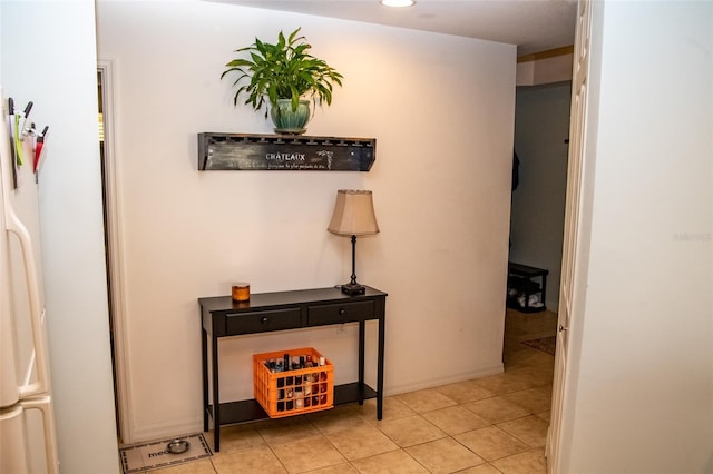 hall featuring light tile patterned floors