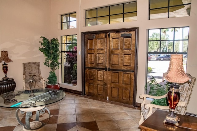 foyer featuring a towering ceiling and tile patterned flooring