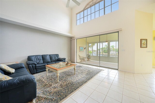 living room with ceiling fan and light tile patterned floors