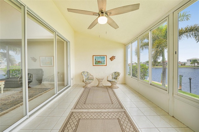 unfurnished sunroom with vaulted ceiling, ceiling fan, and a water view