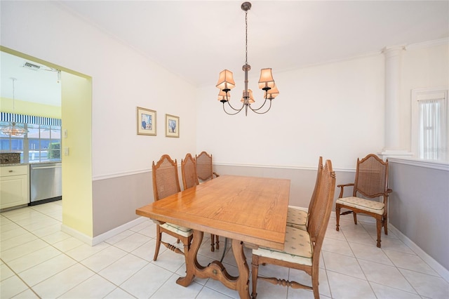 dining area with light tile patterned floors, baseboards, visible vents, ornamental molding, and an inviting chandelier