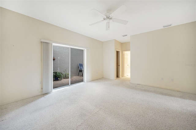 carpeted spare room with ceiling fan